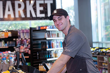 Student smiling and working at Sparty's Market