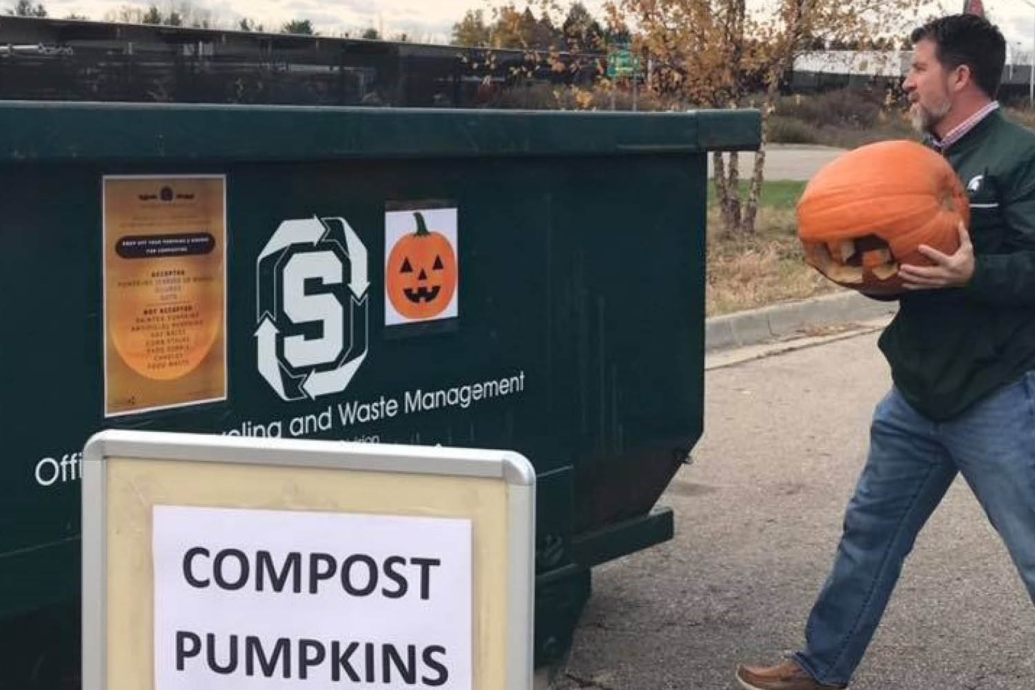 Employee plopping a pumpkin