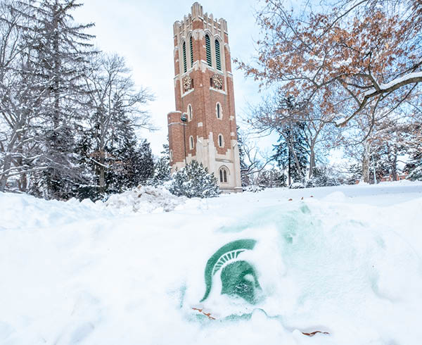 Spartan helmet in the snow in front of Beaumont Tower