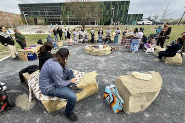 Attendees at the Ceremonial Fire Ceremony gather outside of the MSU Multicultural Center