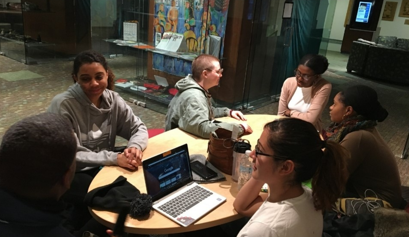 Students gather around a table in the MOSAIC Center for Education and Outreach.