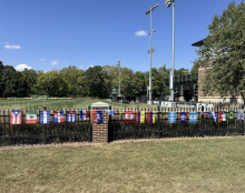 Rows of vibrant flags along the gates of the DeMartin Stadium representing Hispanic/Latine countries