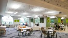 Student sit together near large windows in the newly designed MSU Union community space