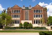 And external shot of the MSU Union building in spring surrounding by blue sky and green trees