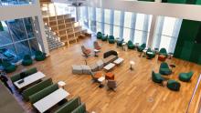 Inside the MSU Multicultural center showing multiple seating options and large windows letting in natural sunlight